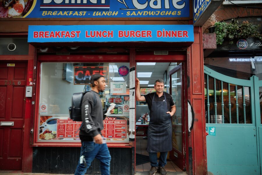 Cafe owner standing in his shop doorway
