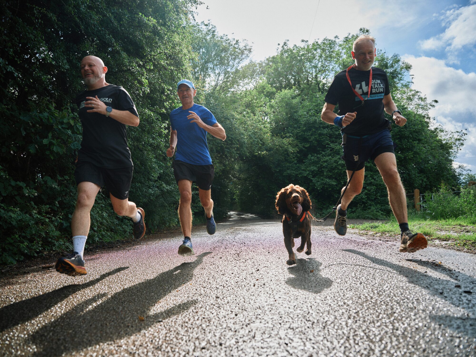 3 men and a dog going for a jog