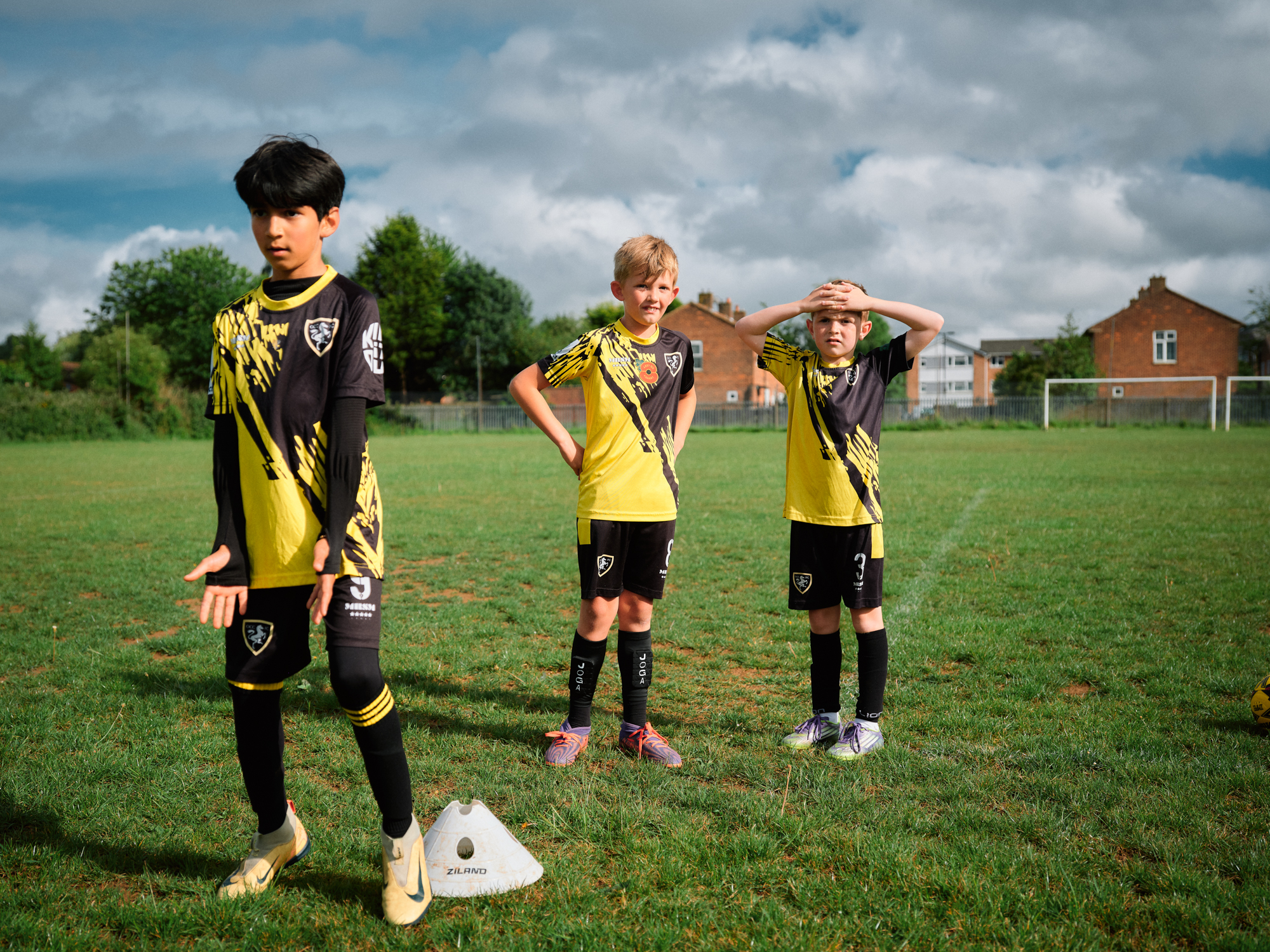 3 young boys at football training