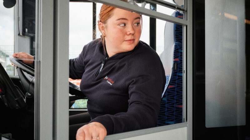 Woman at work driving a bus