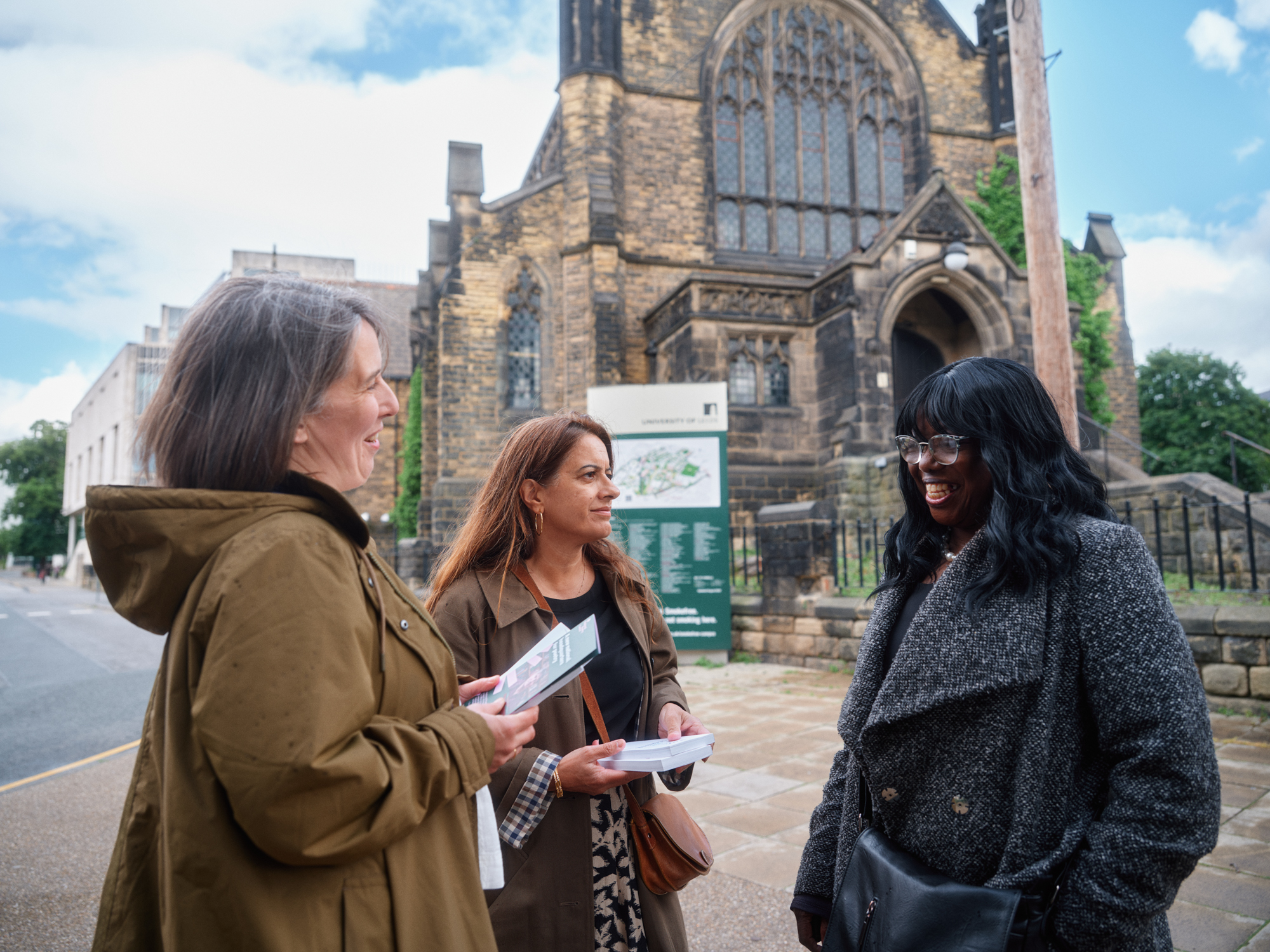 Group of 3 talking outside a church